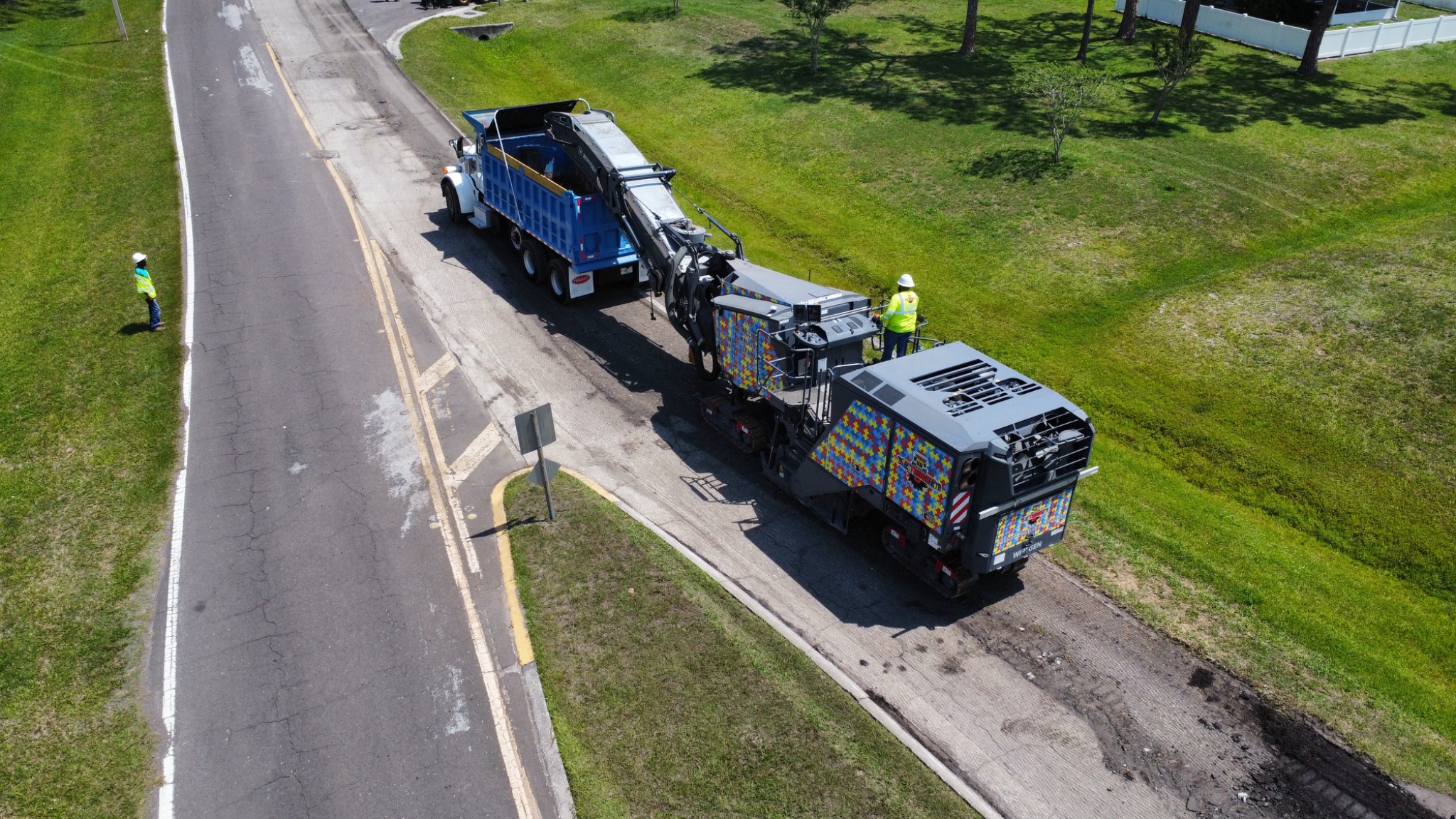 Milling machine loading asphalt into a dump truck