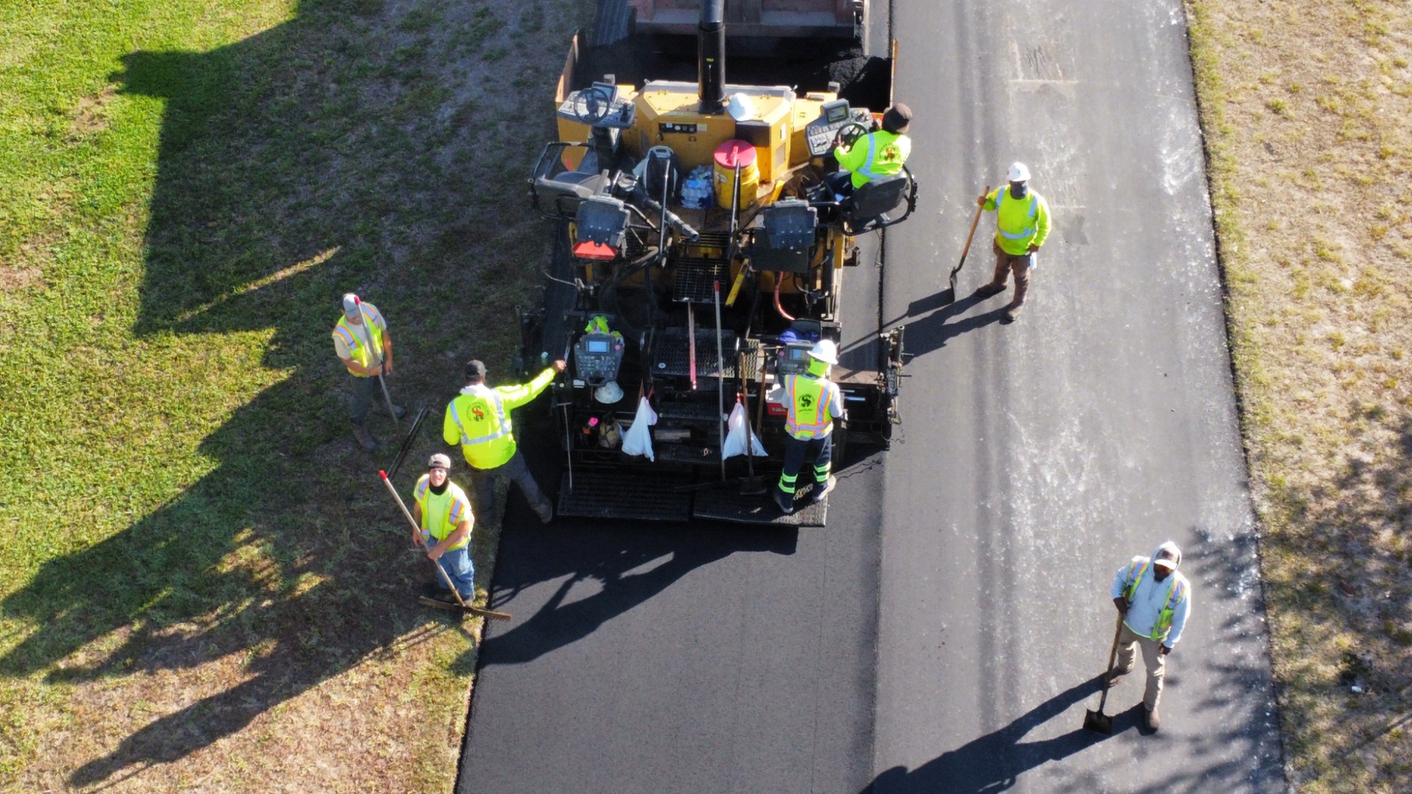 Crew paving fresh asphalt